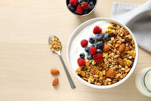 istock Delicious granola with berries and yogurt on a light background 2252690103