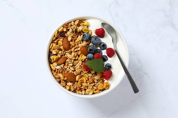 istock Delicious granola with berries and yogurt on a light background 2252690123