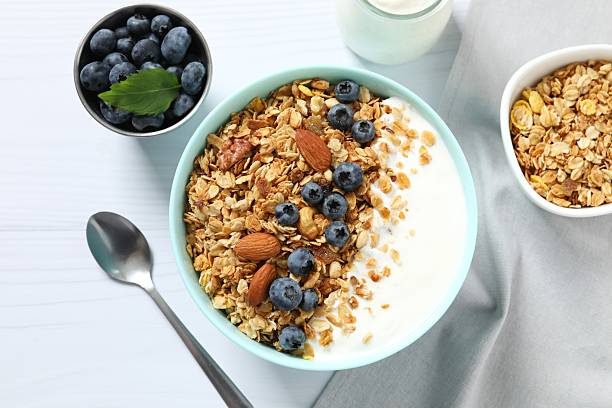 istock Delicious granola with berries and yogurt on a light background 2252690217