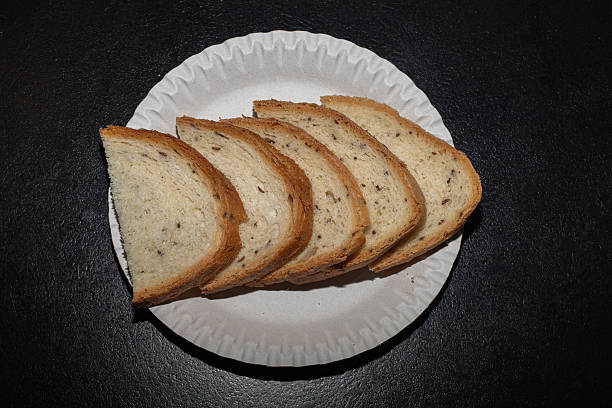 istock Bread cut into pieces lies on a white plate 2252690754