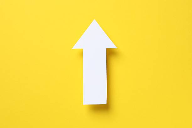 istock Paper arrow on color background, top view 2252691038
