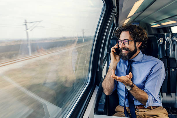 istock Businessman talking on phone while traveling by train 2252692383