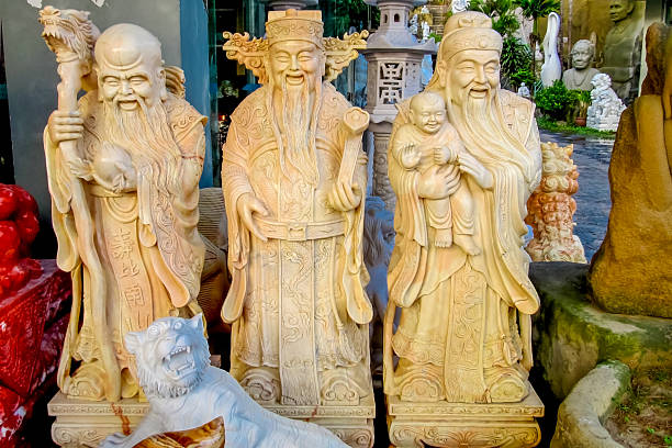 Ho Chi Minh, Vietnam 12 December 2015: Traditional Vietnamese statues displayed in temple setting, carved figures with historic details, cultural heritage art, Asian religion sculpture, stone and wood materials, travel destination in Vietnam