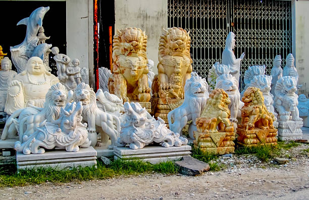 Small rock carved guardian lion statue with a white background