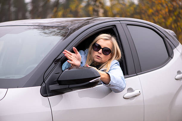 istock Middle Aged Woman Gesturing From Car Window 2252695488