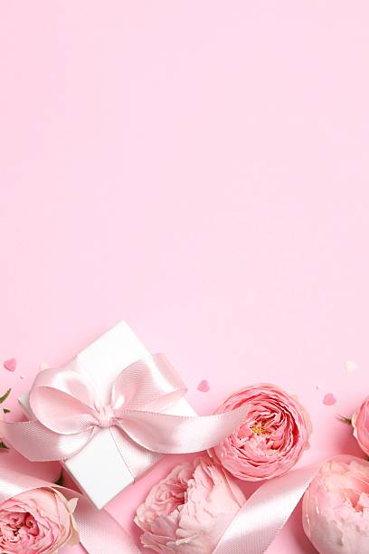 istock Beautiful composition with pink roses and gift box on color background 2252696583