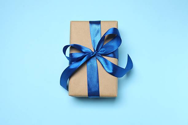 istock Beautiful gift box with satin ribbon on blue background 2252698419