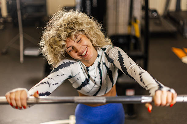istock Young fit woman relaxing while lifting weights in gym 2252699599