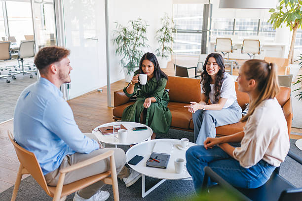 istock Diverse Young Adults Relaxing with Coffee in Open Office Space 2252700029
