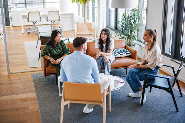 istock Young Professionals Enjoying Coffee Break in Bright Office Lounge 2252700044