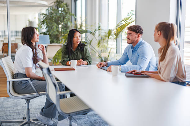 istock Young Professionals Engaging in Productive Meeting at Office Table 2252700089