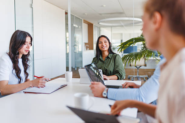 istock Young Adults Collaborating Enthusiastically in Modern Boardroom Setting 2252700228