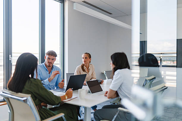 istock Young Professionals Collaborating on Project in Bright Conference Room 2252700285