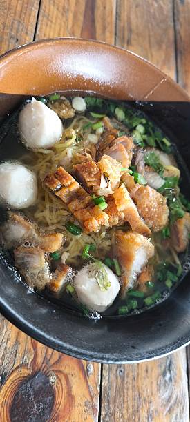 istock Noodle soup in a ceramic bowl on a wooden table 2252701654