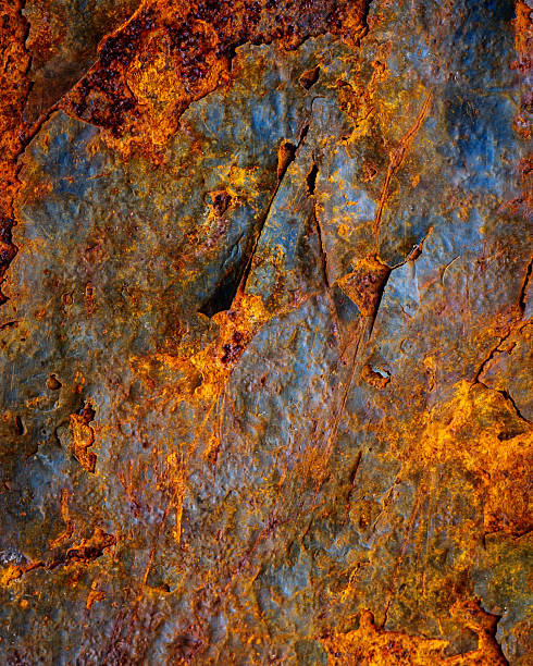 Rusty metal surface with shabby background paint. Blue cracked paint texture on an iron sheet. Fragment of an old metal door, Metal corrosion.