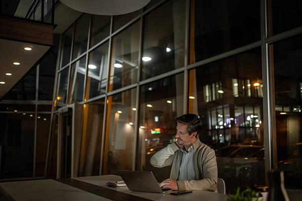 istock Man experiencing neck pain working late at office 2252703603