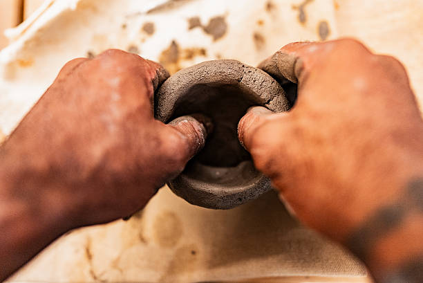 Close-up of man modeling clay in an art class