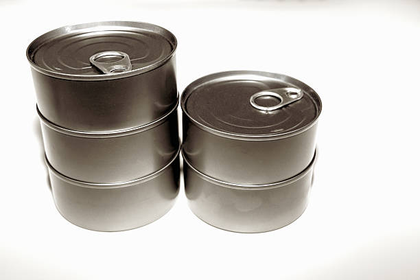 Group of tuna cans arranged together on white surface