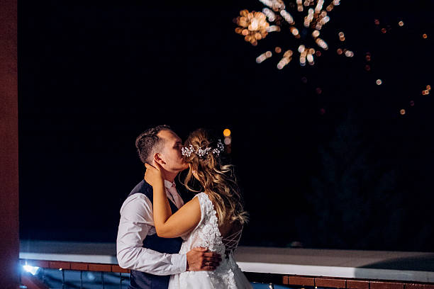 istock A newlywed couple watches a wedding fireworks display against 2252707603