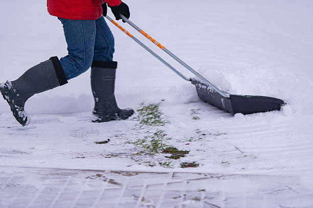 istock Close-up of a snow shovel, a man doing physical labor 2252707824
