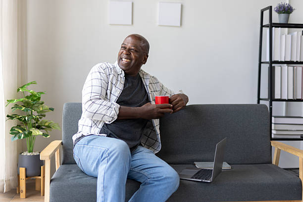 istock Senior man relaxing at home with coffee, enjoying view from window. 2252707853