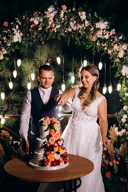 istock newlyweds happily cut and taste the wedding cake 2252708401