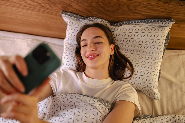 istock Young woman in bed posing for a selfie in bed 2252709501
