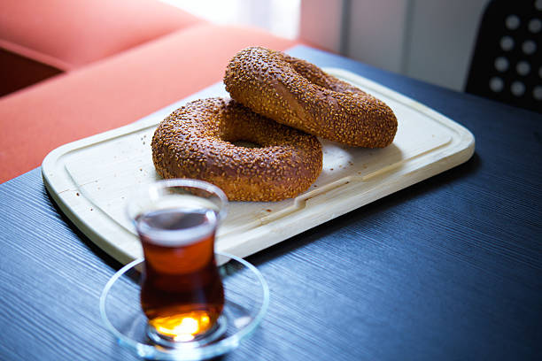 Turkish bagels and a cup of tea on the black table.