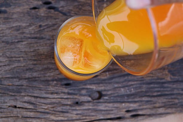 Soft drinks orange juice and iced in glass