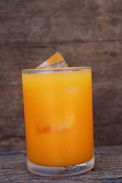 Soft drinks orange juice and iced in glass