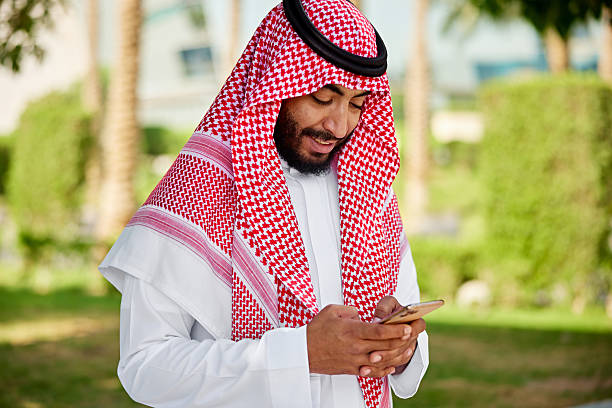 istock Bearded Saudi man text messaging outdoors 2252714462
