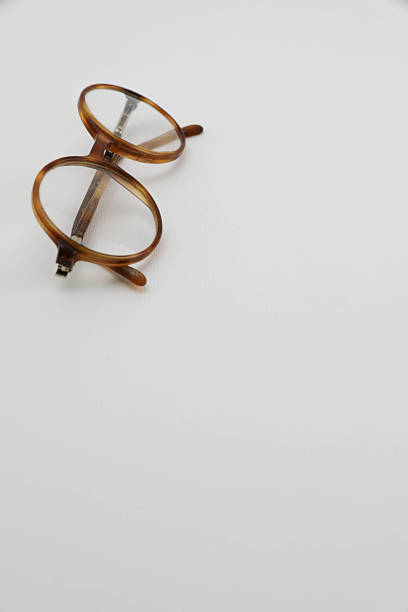 Classic gold round glasses on white background