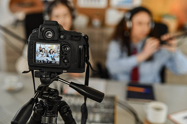 istock Lively Podcast Studio Scene With Two Women Interviewing and Laughing in Front of Camera 2252719672