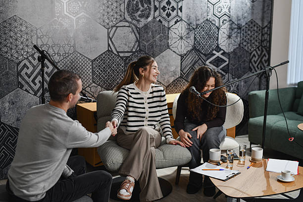 istock Warm and Inviting Podcast Studio Scene With Female Hosts Receiving Guest 2252720622