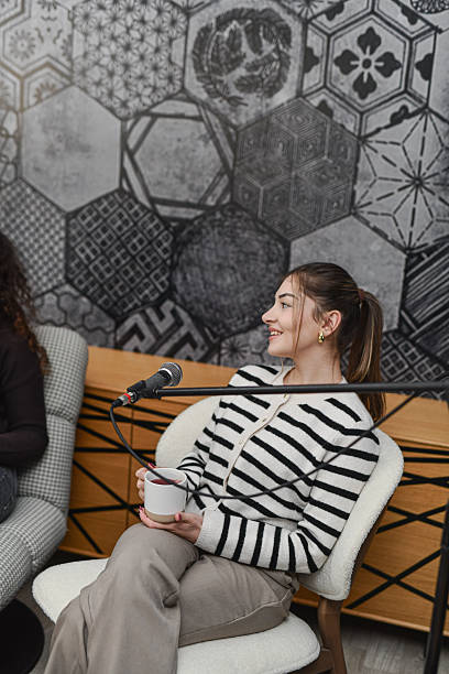 istock Relaxed Podcast Conversation With Woman Speaking Into Microphone In Modern Studio 2252721371