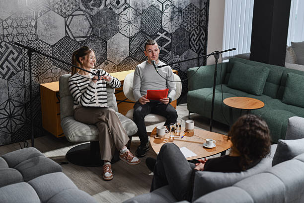 istock Cozy Podcast Studio Discussion With Hosts And Guest On Microphones In Modern Lounge Set 2252721882
