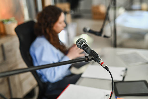 Casual podcast scene featuring a host and microphone in a bright studio. The setup conveys relaxed conversation, interview style, and positive energy with a focus on storytelling and music moments.