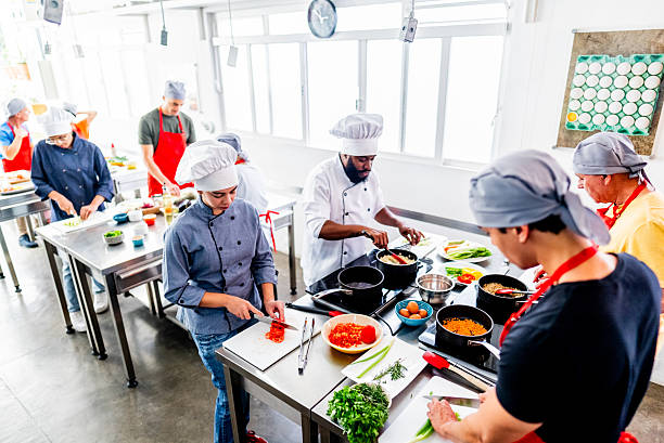 Sliced vegetables and fresh ingredients organized in trays in a professional kitchen. Culinary preparation for cooking in a restaurant environment.