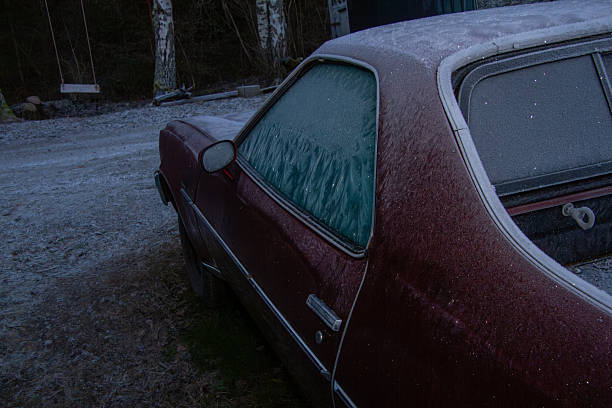 An ice scraper is needed to clean the frozen windows to start up the day.