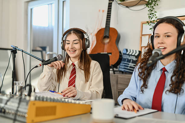 istock Two Podcasters Hosting a Fun and Relaxed Session, Engaging With Guests and Online Audience While Using Microphones 2252722857