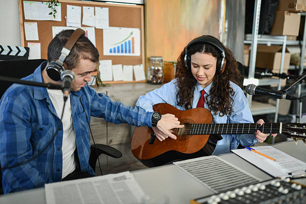 istock Podcast Duo Recording Session With Guitar, Microphones, And Friendly Studio Vibes 2252723310