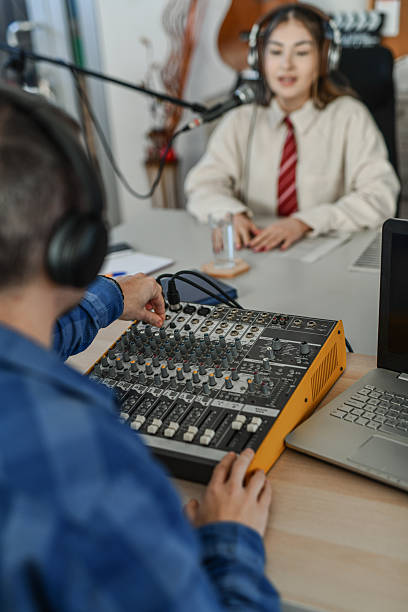 istock Host Giving Directions to Audio Technician in Studio 2252723794