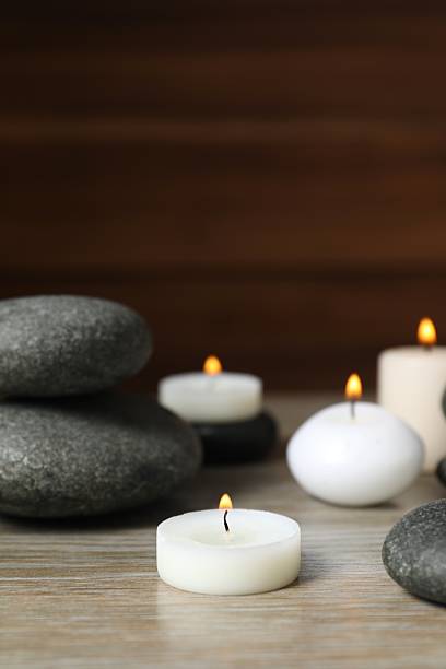 istock Burning candles, spa stones on the table, close up 2252724969