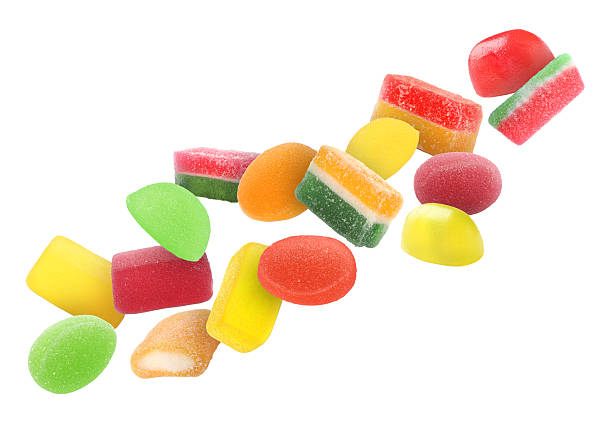 istock Different jelly candies falling against white background 2252725090