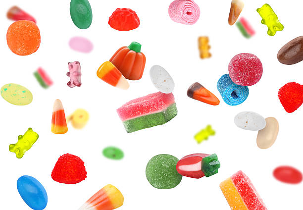 istock Different jelly candies falling against white background 2252725092