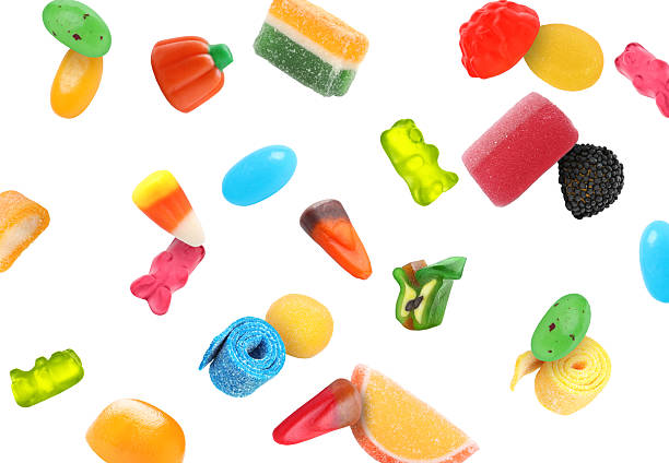 istock Different jelly candies falling against white background 2252725095
