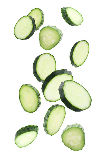 istock Pieces of fresh cucumbers falling on white background 2252725139