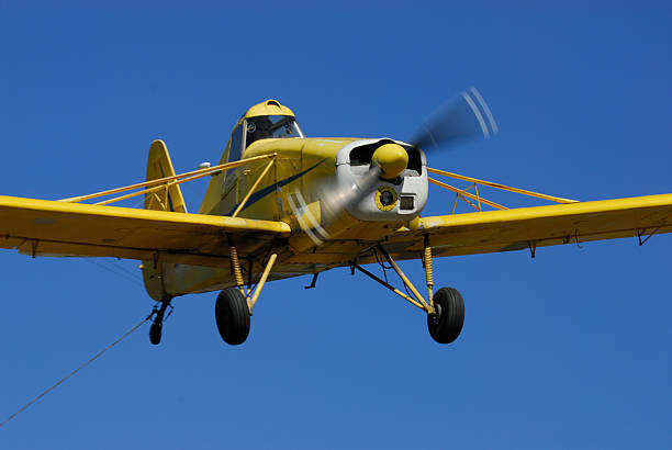 crop duster sprays lentil field in saskatchewan