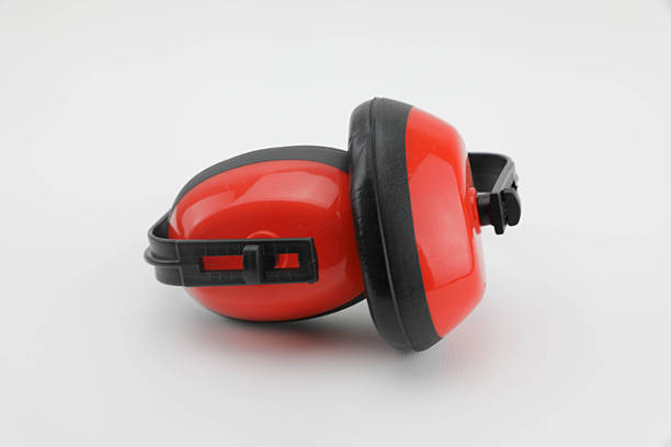 Red Protective Ear Muffs On White Background, Designed For Hearing Protection In Construction, Workshops, And Loud Environments. Clean Studio Composition With Space For Adding Text Or Safety Messages, Highlighting Workplace Safety And Noise Reduction Equipment.