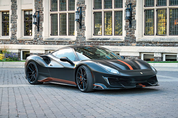A Ferrari 488 Pista is parked in Banff, Alberta, Canada, on a sunny day.
